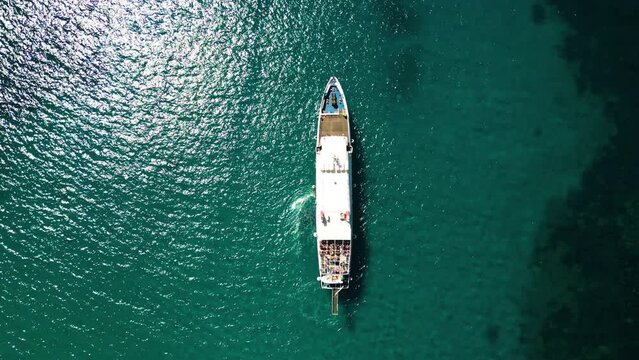 Aerial view of sailing boat in turquoise sea water