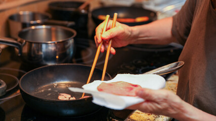wooden chopsticks resting on a ceramic dish, depicting Asian dining culture and traditional utensils in a minimalistic setting