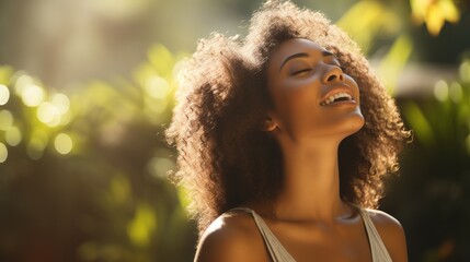 Beautiful American African woman taking a deep breath in blurred garden background with sunlight.