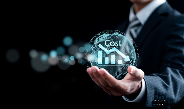 Cost reduction Concept. Businessman holding global network with graph with down arrow icon for budget management and cost management.