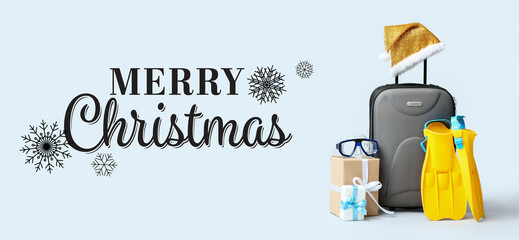 Naklejka premium Greeting banner for Merry Christmas with suitcase, beach accessories and gifts