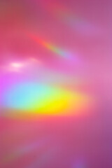 Obraz premium Defocused abstract purple background with rainbow flare from sunlight, holiday backdrop, celebration wallpaper. Colorful sparkle sun glare, Glittering aesthetic textured photo pattern, trend