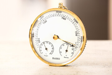 Aneroid barometer on table in room, closeup