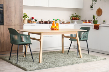 Interior of modern kitchen with wooden dining table
