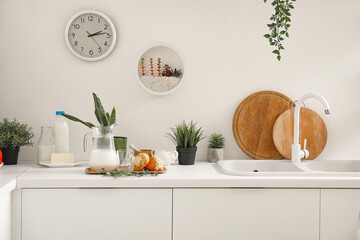 Kitchen counter with sink, croissants and houseplants