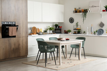 Interior of modern kitchen with white dining table