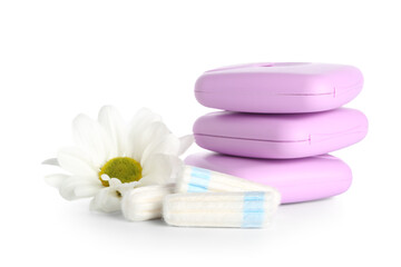 Menstrual tampons, storage boxes and chamomile flower on white background