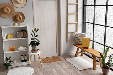 Interior of modern hallway with wooden bench and houseplants