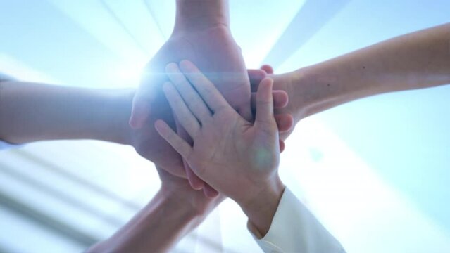 Team huddle business work joining hands committed to mission concept business team putting hands on top of each other