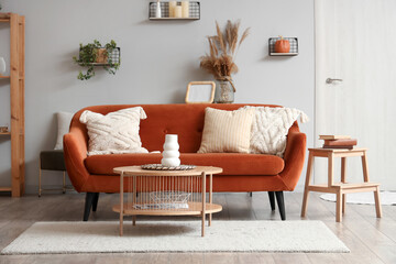 Interior of modern living room with brown sofa and wooden coffee table