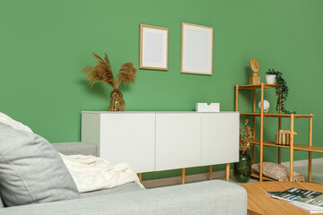 Interior of stylish living room with modern white chest of drawers