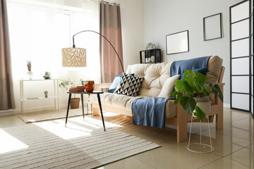 Interior of modern living room with white sofa, coffee table and standard lamp