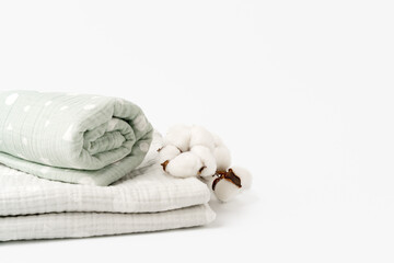 Fototapeta na wymiar Muslin baby blankets with cotton flowers on white background