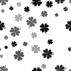 Seamless vector pattern with four-leaf clover symbols, creating a creative monochrome background with rotated elements. Illustration on transparent background