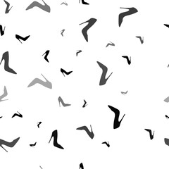 Seamless vector pattern with High heel shoe symbols, creating a creative monochrome background with rotated elements. Vector illustration on white background