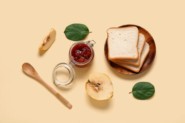 Jar of jam with quince fruits and toasts on beige background