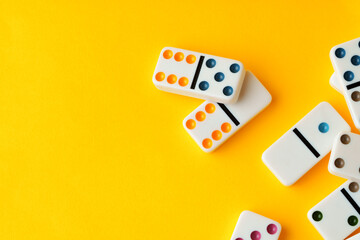 Domino tiles on yellow background studio shot