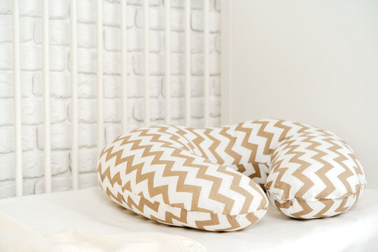 Nursing breast feeding pillow on a bed