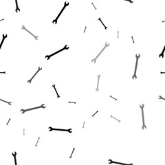 Seamless vector pattern with wrench symbols, creating a creative monochrome background with rotated elements. Illustration on transparent background
