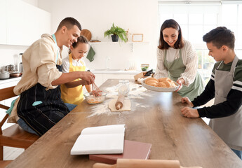 Happy family preparing dough in kitchen