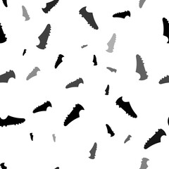 Seamless vector pattern with football boot symbols, creating a creative monochrome background with rotated elements. Vector illustration on white background