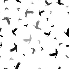 Seamless vector pattern with eagle symbols, creating a creative monochrome background with rotated elements. Vector illustration on white background