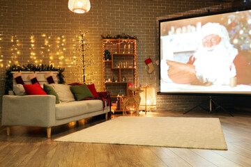 Interior of living room with Christmas lights, sofa and projector screen