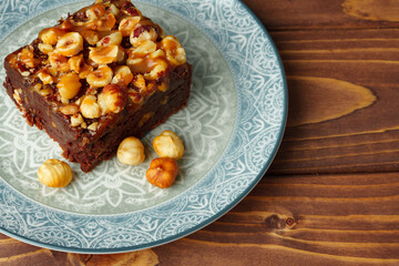 Brownie cake with chocolate and hazelnuts on plate