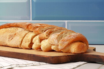 Fresh bread on wooden cutting board in the kitchen