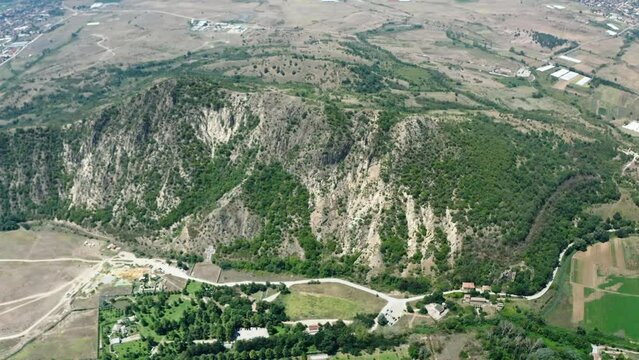 An overhead drone shot of a cross sculpture built for the consecration of St. Petka in Rupite, Bulgaria in comemmoration of the volcano eruption victims in front of the St. Petka church.
