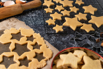 Cutting cookies in the shape of stars from the dough.