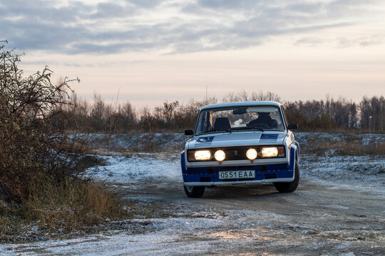 Harju County, near Tallinn, Estonia - November 18th 2023: retro Lada VFTS B-group rally car with soviet licence plates taking practice laps on race track, front view drifting with copy space