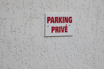 parking prive french text sign red means private parking car parked in city street