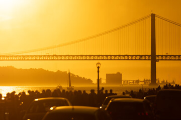 Cars Parked in Front of a Bridge at Sunset