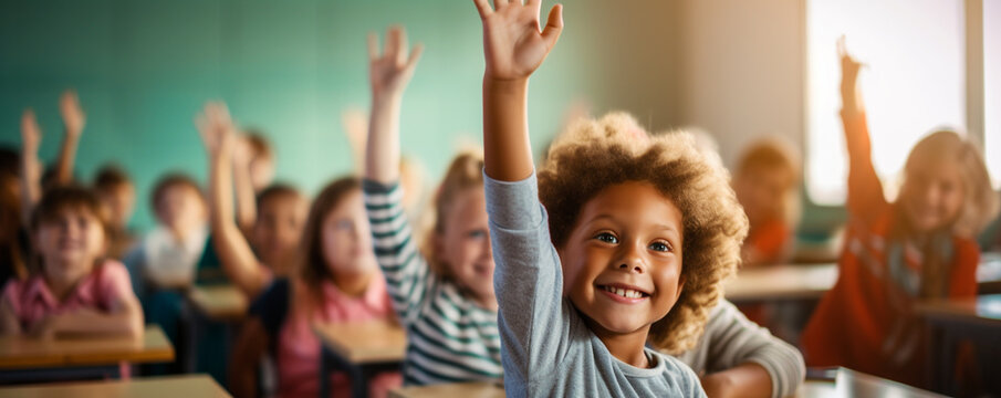 Pupils raising their hands during class at the elementary school