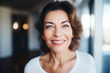 Headshot of a Smiling attractive Hispanic mature senior woman looking at the camera smiling - obrazy, fototapety, plakaty