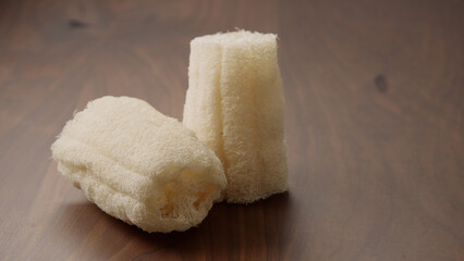 Loofah sponge on walnut wood table,   shot