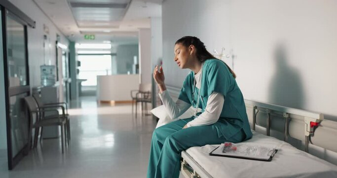 Nurse, tired woman and stress about medical report, healthcare and job with rest on hospital bed. Frustrated, burnout or fatigue with caregiver and health insurance paperwork or results on clipboard