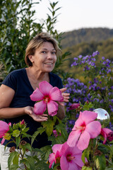 A beautiful woman is surprised by the size of a hibiscus flower