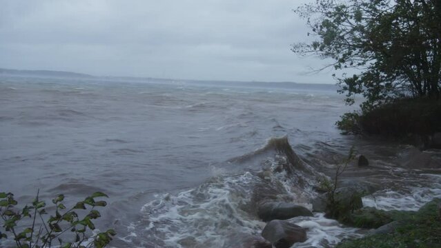 Forceful storm surge in Flensburg Fjord, Northern Germany, with wind-driven waves.
