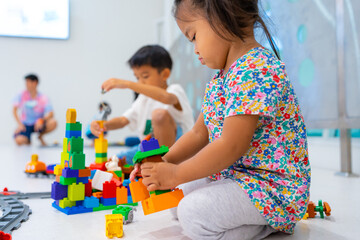 Toddler 2 year girl enjoying build toy block happy girl learnning education - 680421894
