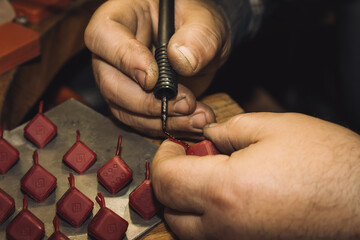 Jeweler working with wax model in his workshop. Craft jewelery making. Detail shot with low depth...