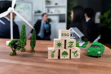 ESG symbol on wooden cube arranged for alternative clean energy utilization and implementation in...
