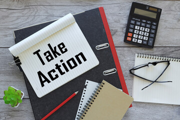 Blackboard with take action now. Monochrome Blackboard with take action now! and cup of coffee on wooden background