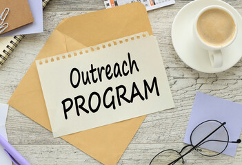 OUTREACH PROGRAM a cup of coffee. coffee. text on torn paper on an envelope