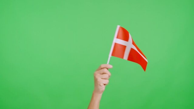 Hand waving a pennant of a danish national flag
