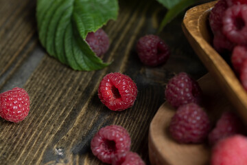 Ripe raspberries on a wooden board