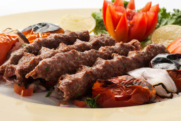 Closeup of four seekh kebab platter and vegetables 