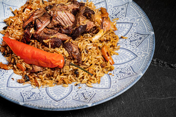 Pilaf with meat and vegetables in a bowl