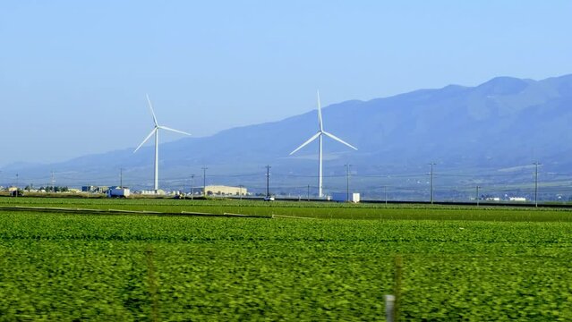 Far view of a wind turbine spinning